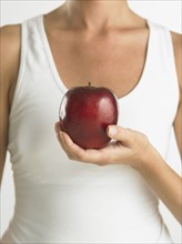 Closeup of woman holding apple.