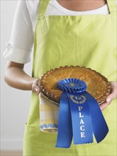 Woman holding prize winning pie.