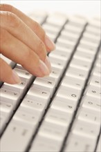 Fingers on computer keyboard.