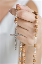 Female hand with rosary.