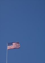 American flag against blue sky.