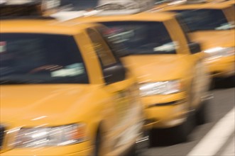 Three taxi cabs on street in New York NY.