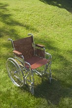 Empty wheelchair on a lawn.