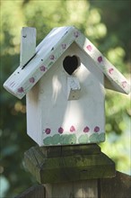 Closeup of wooden birdhouse .