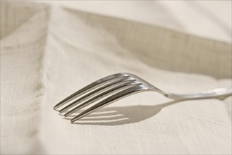 Closeup of metal fork on a napkin.
