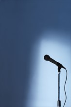 Microphone and stand on an empty stage.