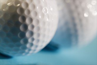Closeup of two golf balls.