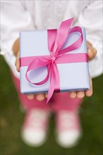 Closeup of a present in a childs hands.
