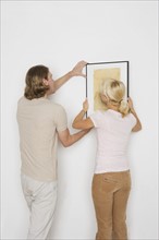 Couple hanging pictures.