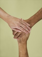 Holding hands in multiracial group.