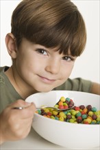 Portrait of boy eating cereal.