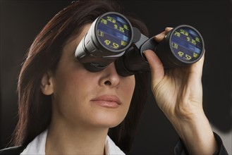 Woman looking through binoculars.