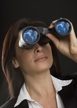 Woman looking through binoculars.