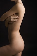 Side view of nude woman posing.