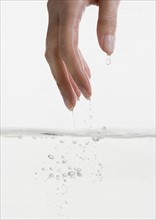 Hand touching water.