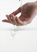 Hand touching water.