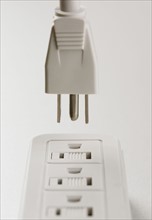 Still life of plug and outlet.