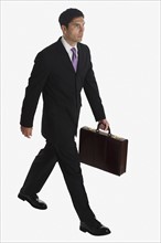 Businessman carrying briefcase.