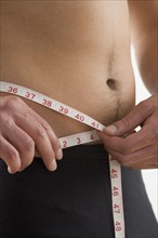 Man measuring his waist.
