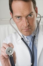 Doctor holding stethoscope.