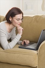 Woman at home using computer.