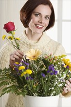 Portrait of woman arranging flowers.