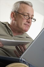 Man using laptop computer at home.