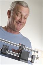 Man weighing himself.