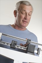 Man weighing himself.