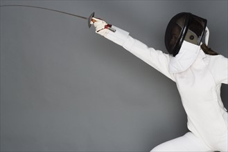 Person engaged in fencing.