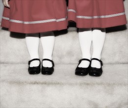 Feet and legs of two girls.