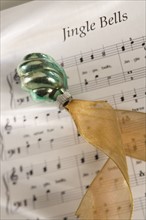 Closeup of Christmas ornanament and music.