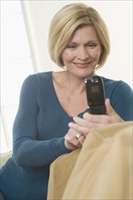 Woman using mobile telephone.