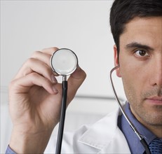 Doctor holding stethoscope.