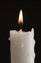 Closeup of a burning candle.