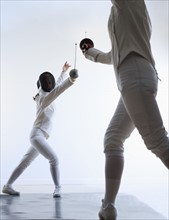 Two people fencing.