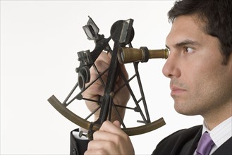 Man holding a sextant.