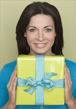 Woman holding wrapped present.