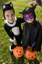 Boy and girl in Halloween costumes.