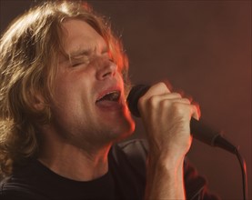 Man singing into microphone.