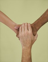 Holding hands in multiracial group.