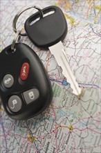 Closeup of car keys and map.