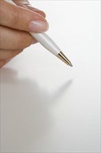 Closeup of hand holding pen.