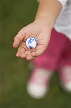 Closeup of earth in childs hand.