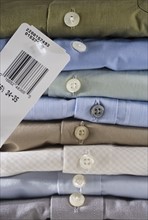 Closeup of a stack of dress shirts.