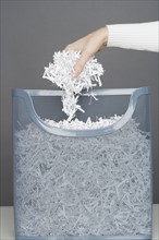 Woman using shredding machine.