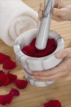 Rose petals in pestle and mortar.