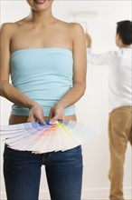 Woman holding color samples.