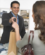 Male salesperson assisting female customer.