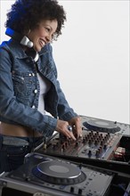 Woman working at a mixing board.